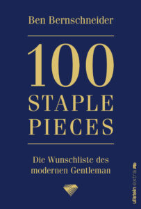Cover von „100 Staple Pieces“ von Ben Bernschneider: Das Buchcover zeigt einen blauen Hintergrund mit goldfarbener Schrift, die schlicht und elegant wirkt.